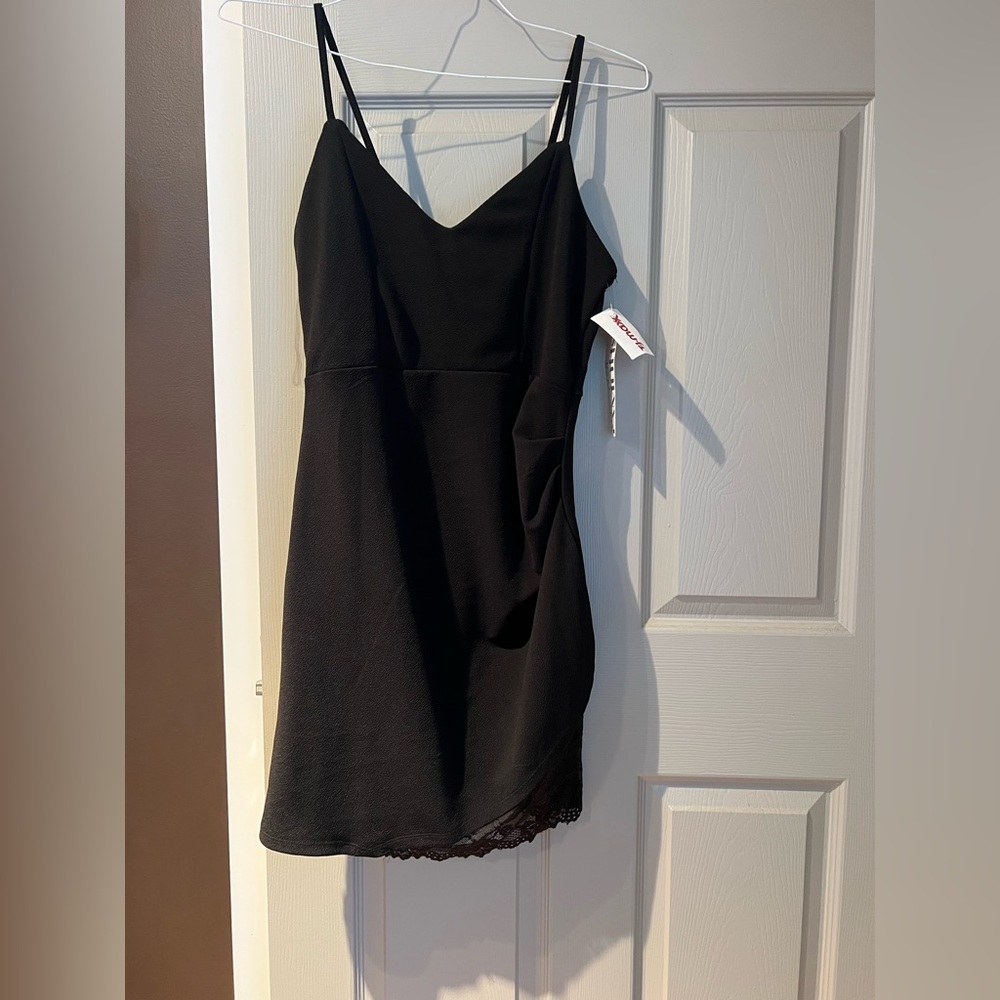 Black mini dress. Cute lace detail. New with tags. Size L.